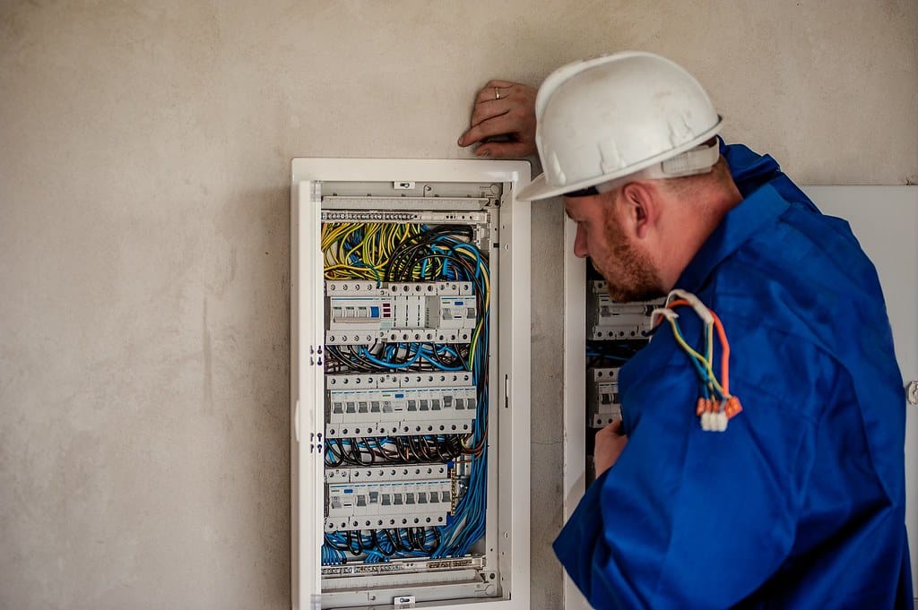 Electrician working inside an electrical panel